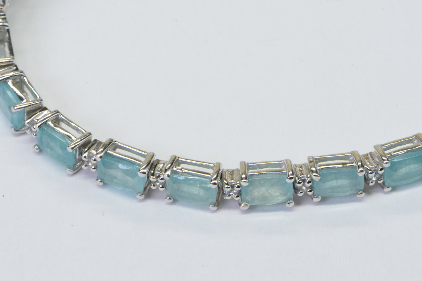 Grandidierite Tennis Bracelet: Emerald Cut Gemstone, Sterling Silver, White Topaz Accents