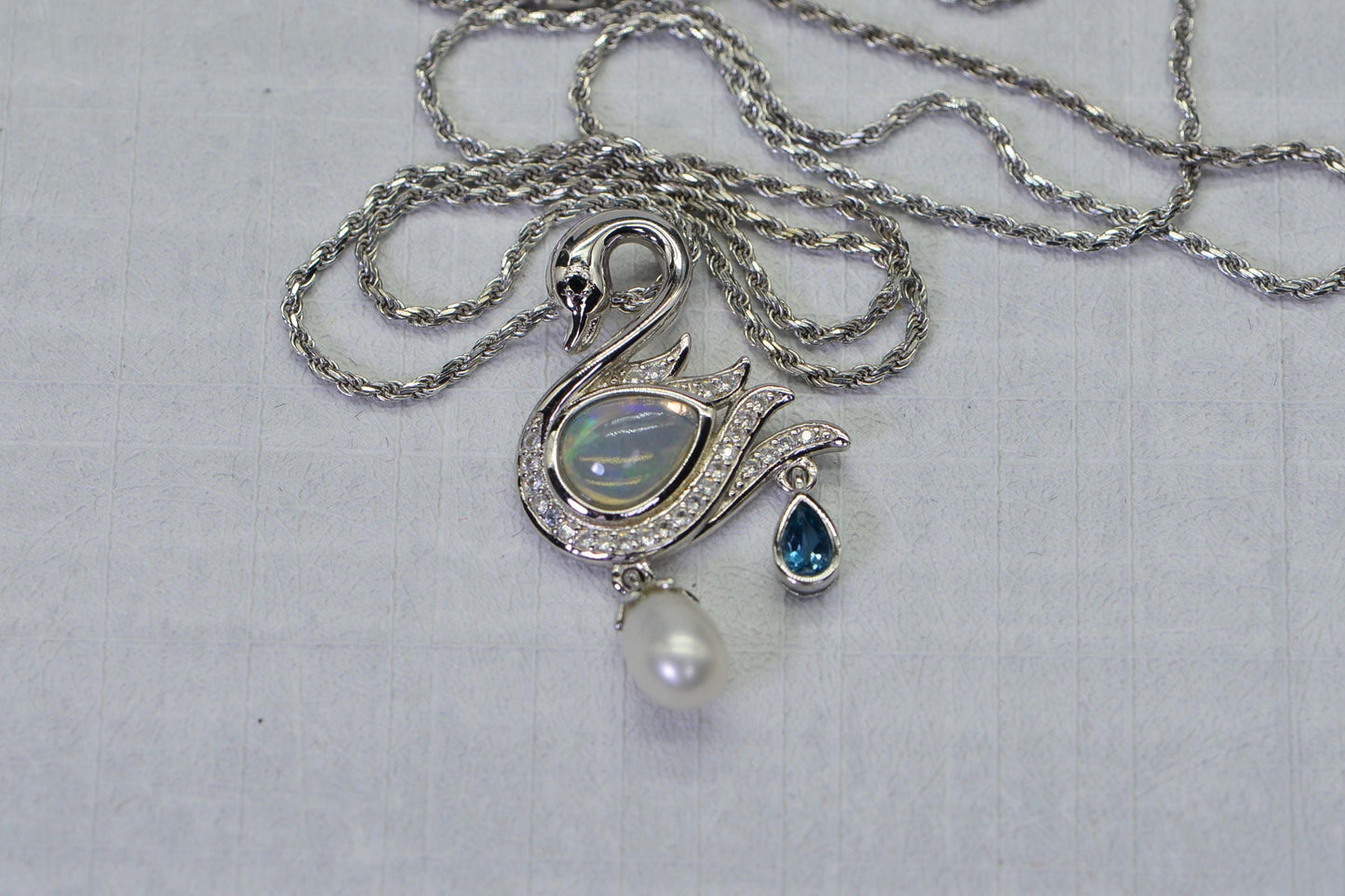 Welo Opal Swan Pendant: 14K White Gold Over Sterling Silver, Pearl & Topaz Accent