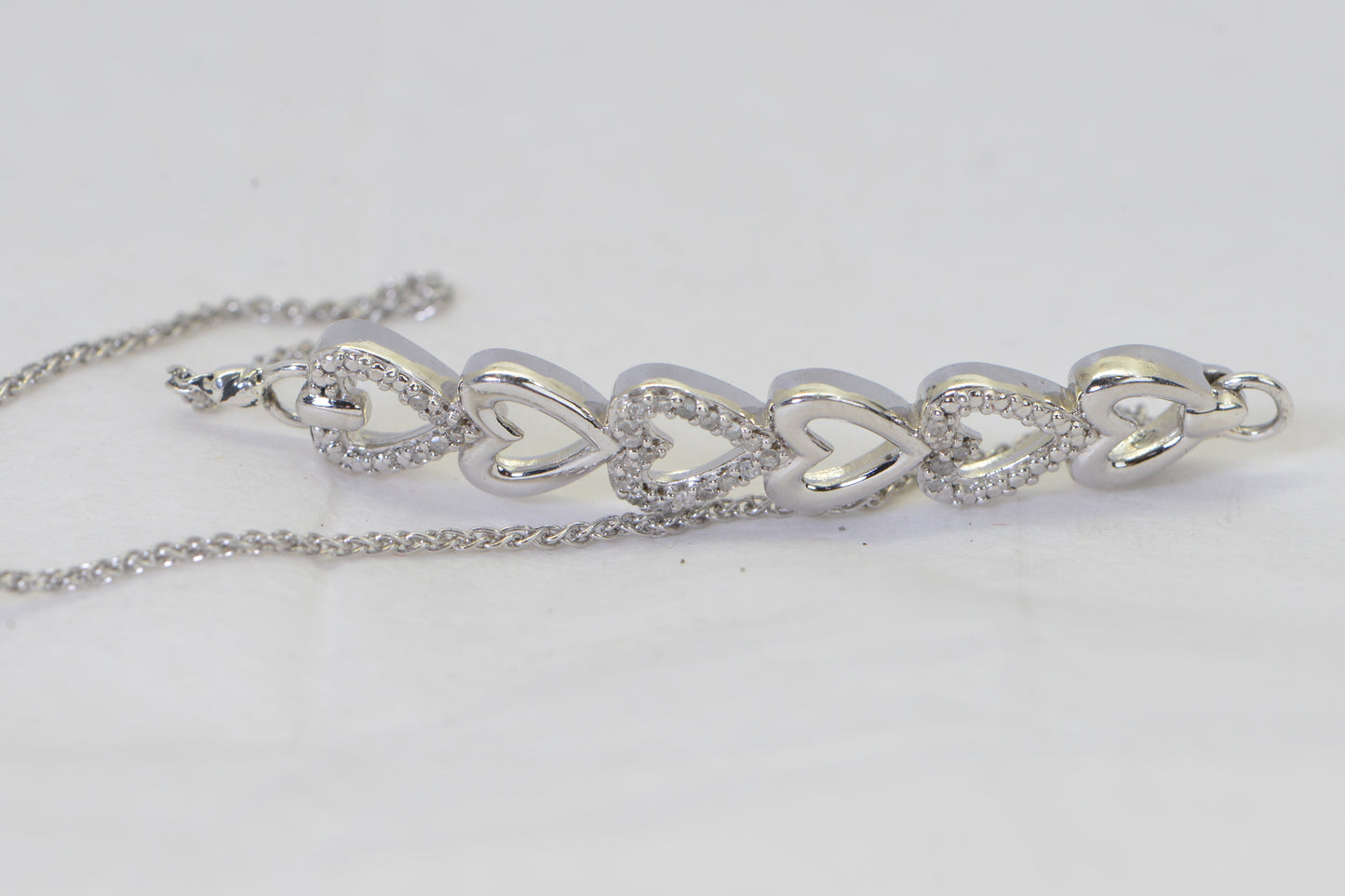 Diamond Six Heart Bracelet: 14k White Gold over Sterling Silver