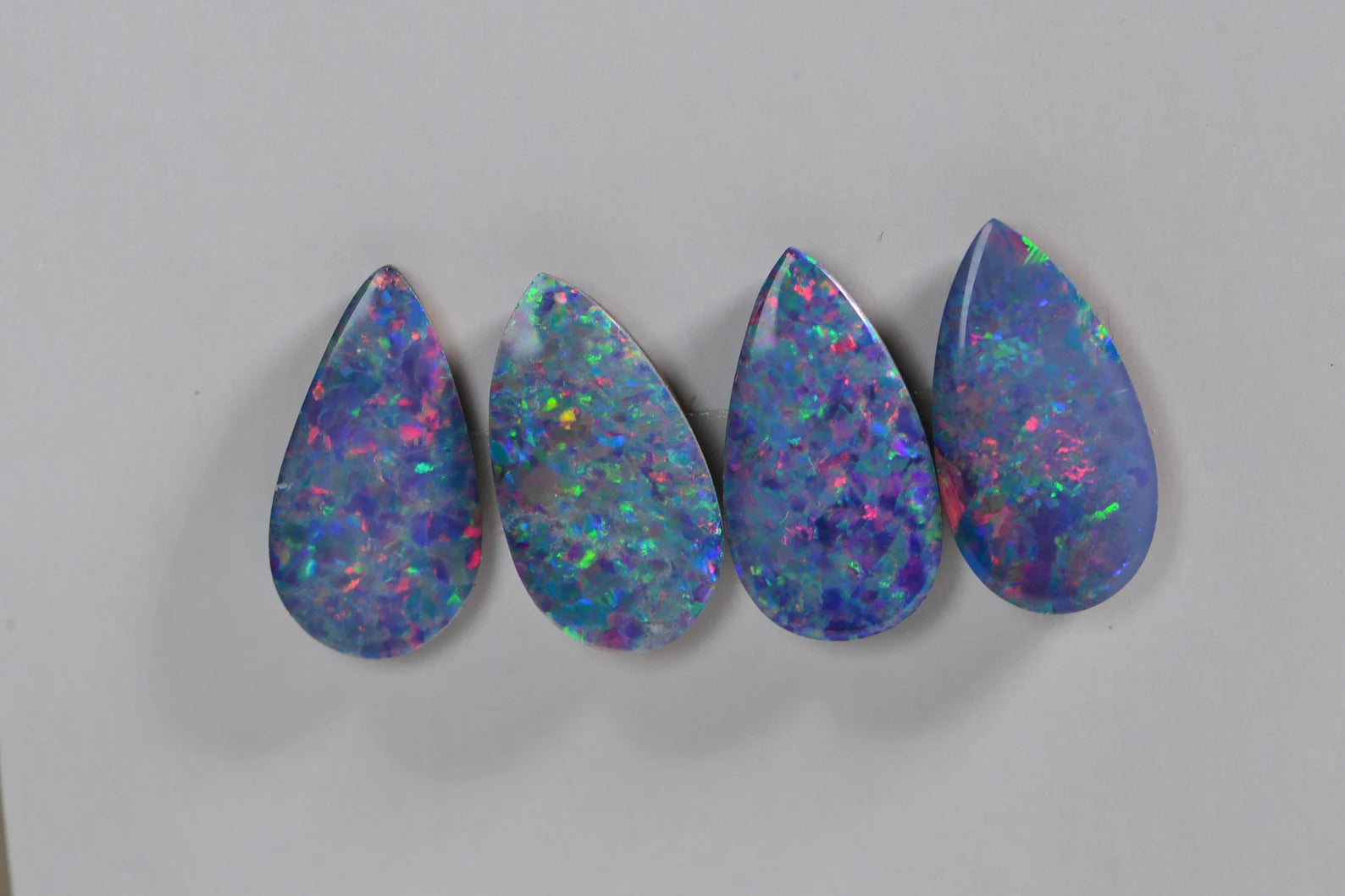 Australian Black Opal Doublet: 0.85CT Pear Cabochon, Blue Broad Flash (11X6mm)