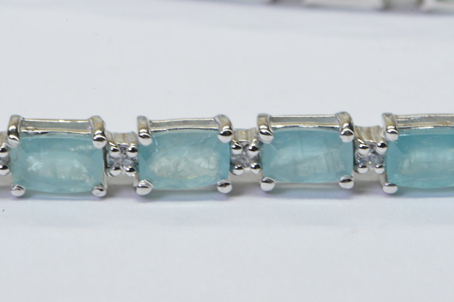 Grandidierite Tennis Bracelet: Emerald Cut Gemstone, Sterling Silver, White Topaz Accents