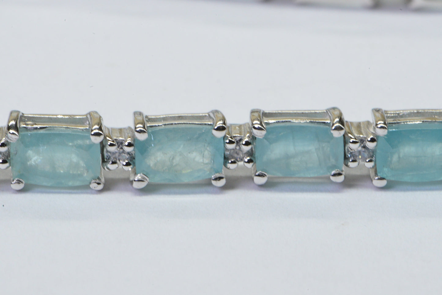 Grandidierite Tennis Bracelet: Emerald Cut Gemstone, Sterling Silver, White Topaz Accents