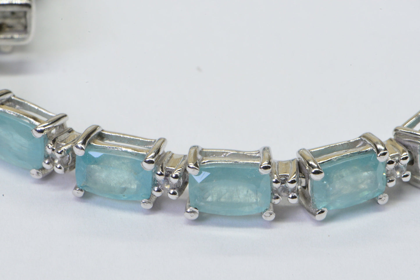 Grandidierite Tennis Bracelet: Emerald Cut Gemstone, Sterling Silver, White Topaz Accents