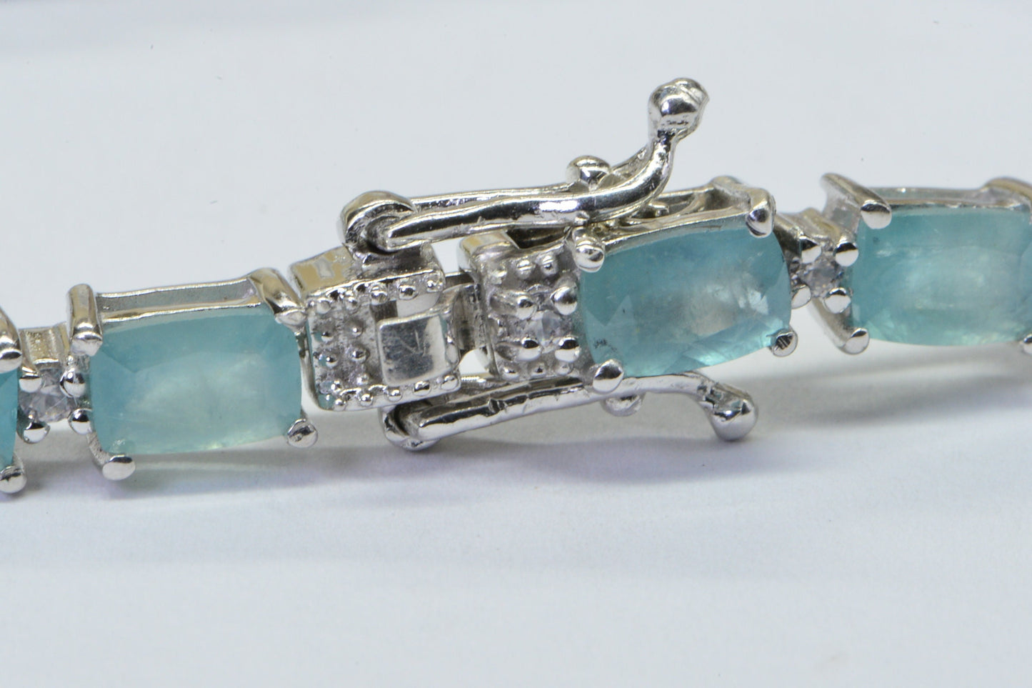 Grandidierite Tennis Bracelet: Emerald Cut Gemstone, Sterling Silver, White Topaz Accents