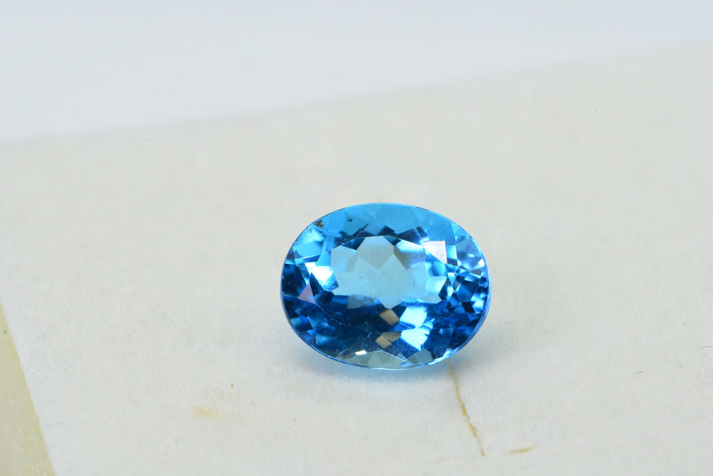 AAA Blue Topaz: Oval Faceted November Birthstone (8X10X5.2mm)