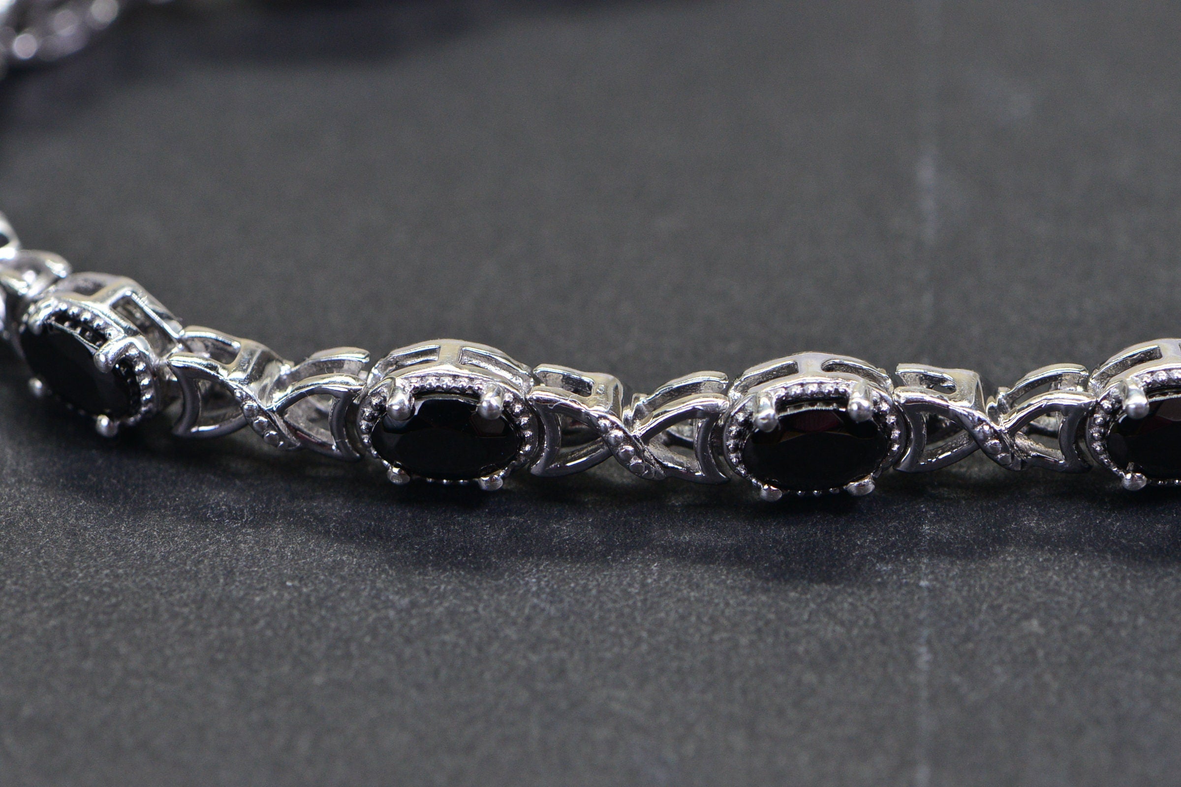 Black Spinel Tennis Bracelet: Oval Gemstone, Sterling Silver