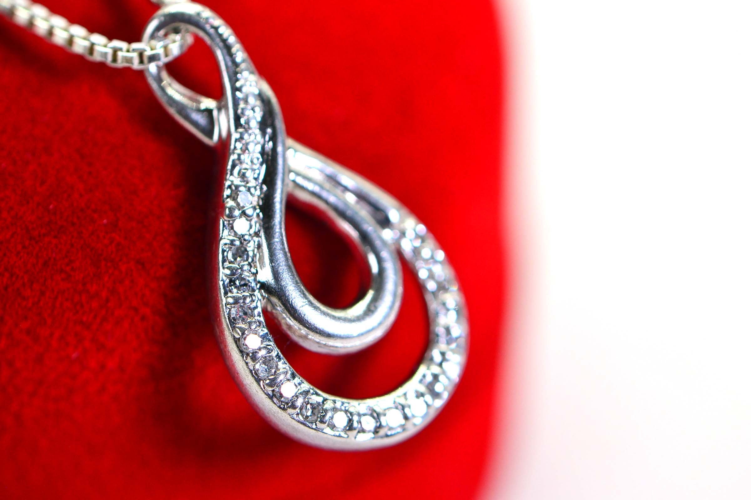 Vintage Diamond Swirl Pendant: Sterling Silver Infinity Loop