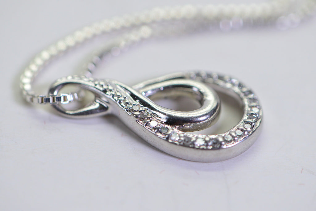 Vintage Diamond Swirl Pendant: Sterling Silver Infinity Loop