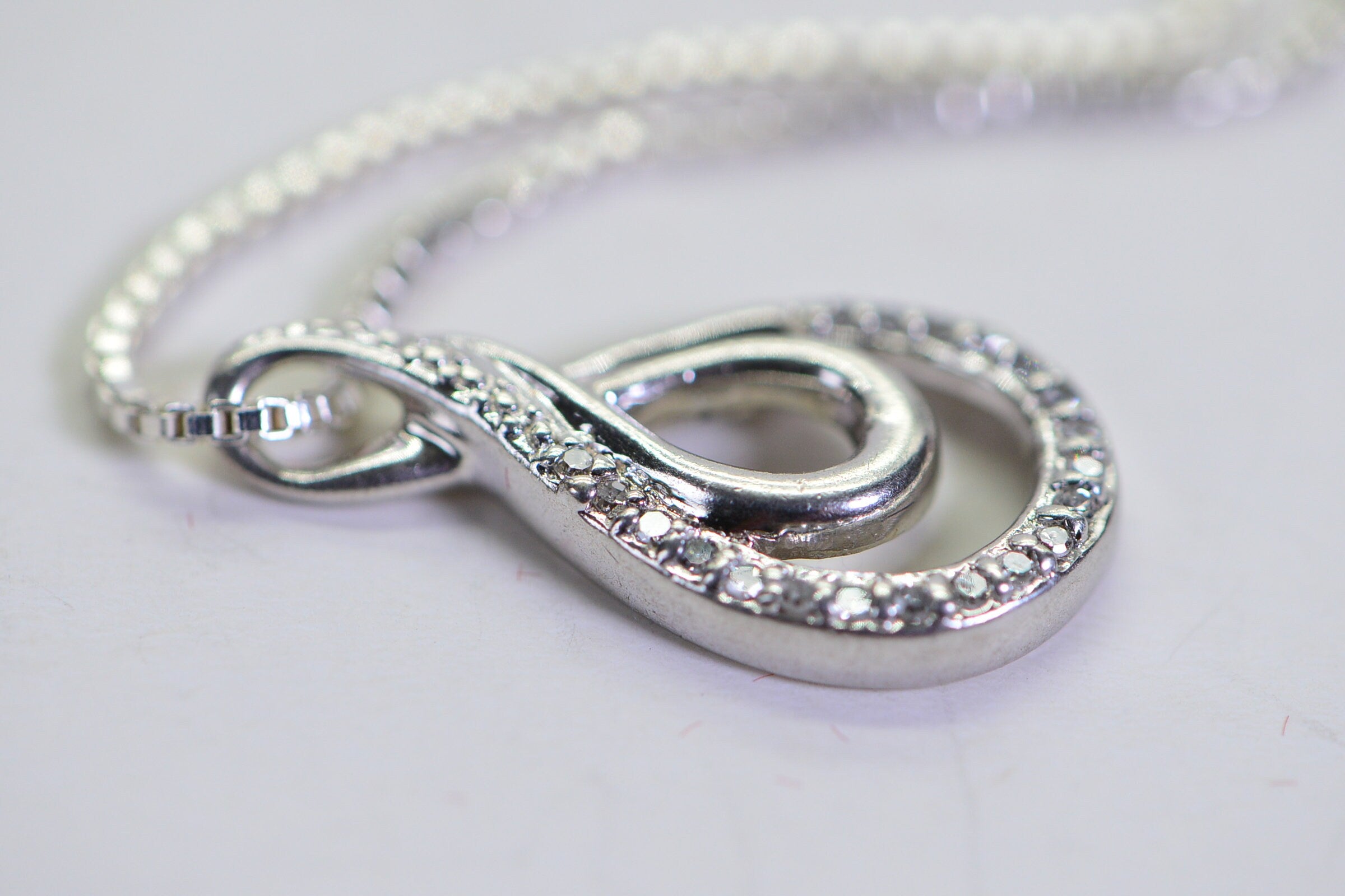 Vintage Diamond Swirl Pendant: Sterling Silver Infinity Loop