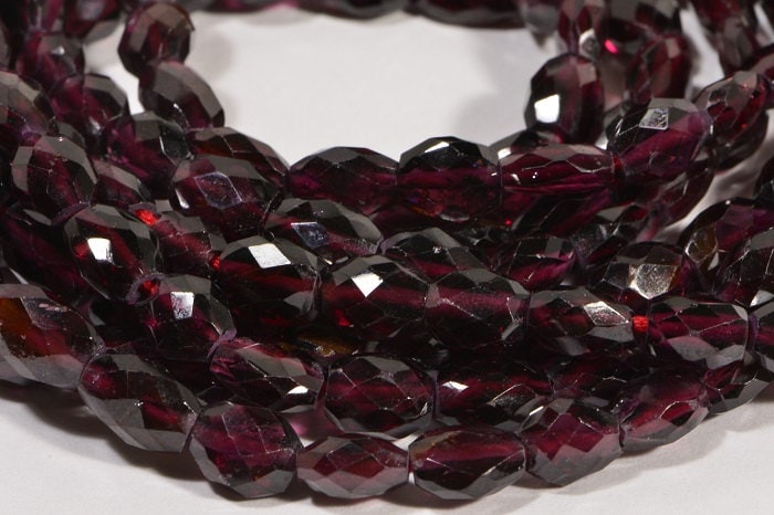 Faceted Garnet Gemstone Beads: Burgundy Red Oval, 7.5" Strand